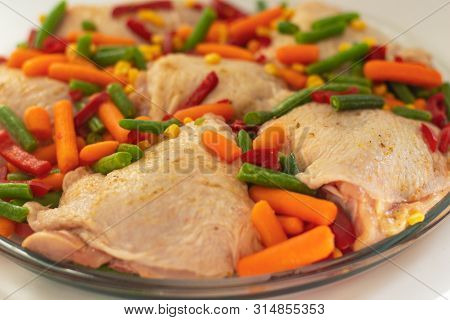 Bits Of The Raw Chicken With Vegetables. Сhicken Thighs With Pepper, Baby Carrot, Green Beans And Sp