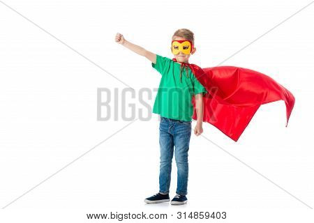 Full Length View Of Smiling Preschooler Boy In Mask And Red Hero Cloack Standing With Fist Up Isolat
