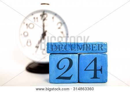 December 24th. Day 24 Of Month, Handmade Wood Calendar And Alarm Clock On  Blue Color. Winter Month,