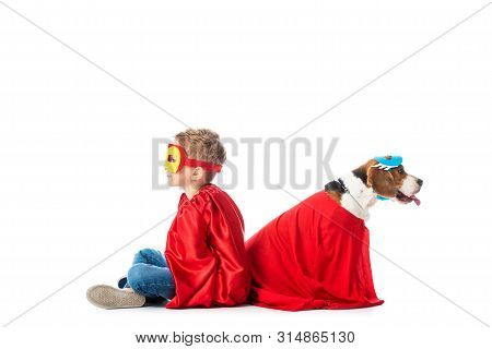Preschooler Child And Beagle Dog In Masks And Red Hero Cloacks Sitting Back To Back Isolated On Whit