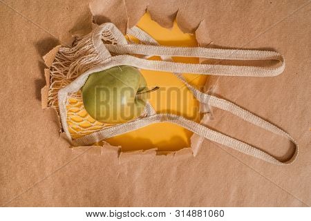 Fresh Fruit In A String Bag. Orange, Lemon And I Are Blocky. Ecological Packaging. Hole In Craft Bac