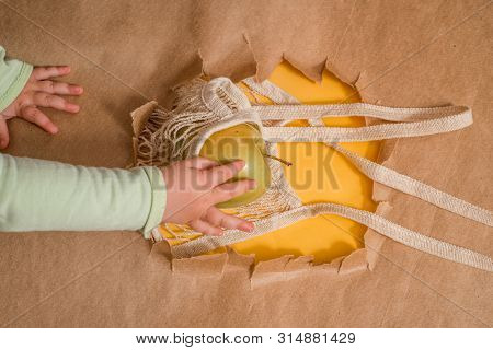 Fresh Fruit In A String Bag. Orange, Lemon And I Are Blocky. Ecological Packaging. Hole In Craft Bac