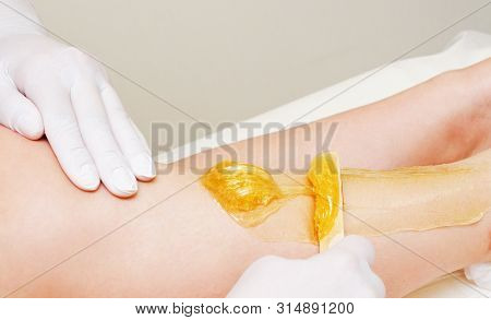 Cosmetologist Beautician Waxing Female Legs In The Spa Center Beauty Salon Cosmetology Concept