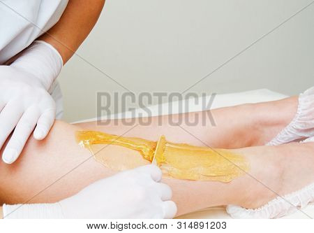 Cosmetologist Beautician Waxing Female Legs In The Spa Center Beauty Salon Cosmetology Concept