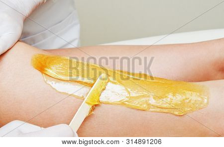 Cosmetologist Beautician Waxing Female Legs In The Spa Center Beauty Salon Cosmetology Concept