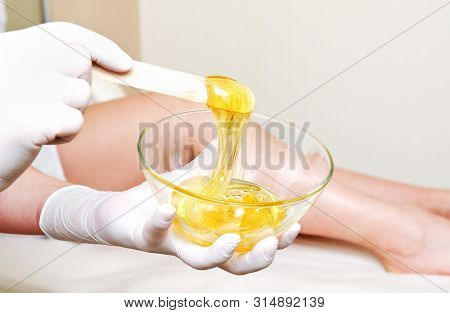 Cosmetologist Beautician Master Holding Bowl With Hot Wax For Depilation Epilation Hair Removal Proc