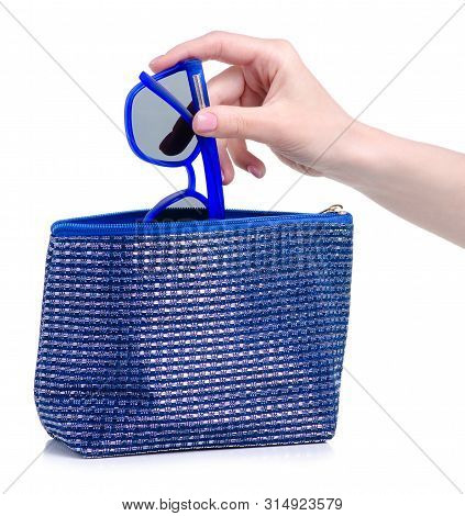 Blue Sunglasses Put In Blue Cosmetic Bagon A White Background. Isolation