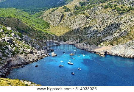 Sea Bay With Turquoise Water, Beach And Mountains, Cala Figuera On Cap Formentor