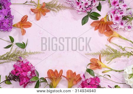 Colorful Flowers Of Pink, Red Phlox And Lily On A Pink Table With Place For Text, Top View, Flat Pla