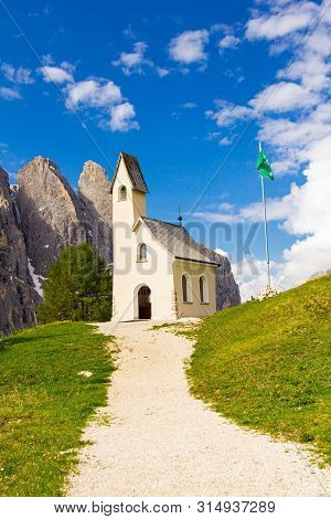 San Maurizio Chapel On The Passo Di Val Gardena With Mountain View In Background. Colorful View In P