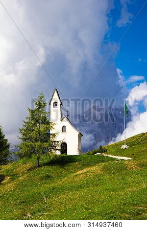 San Maurizio Chapel On The Passo Di Val Gardena With Mountain View In Background. Colorful View In P