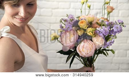 Portrait Of Woman Creating Flower Compositions In Art Studio. Teacher Of Floristry In Master Classes