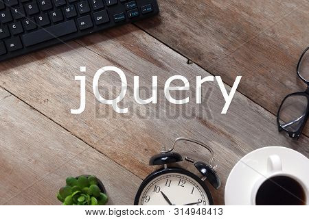 Top View Of Keyboard,sunglasses, A Cup Of Coffee,clock And Plant On Wooden Background Written With J