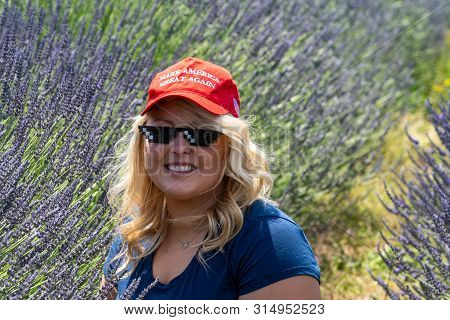 Hood River, Oregon - July 8, 2019: Blonde, Sexy Republican Woman Donald Trump Supporter Wears A Maga