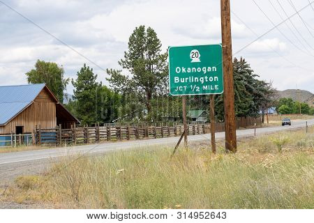 Sign For Washington State Highway 20 Junction, Toward Towns Of Okanogan And Burlington. As Seen From