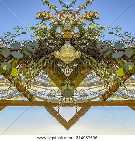 Square Frame Chuppah Refleced In Half At A Jewish Wedding With Sunset Behind