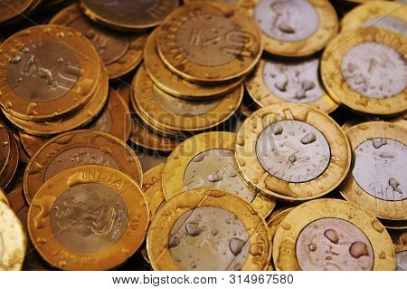 Close-up Of 10 Rupee Coins With Water Drops