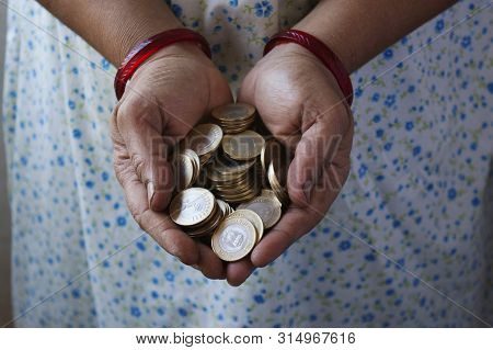 Woman Holding 10 Rupee Coins In Hands, Close-up