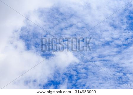 Blue Sky Background And White Clouds In Sunny Day