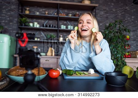 Young Beautiful Blonde Takes On Videos As She Cooks In The Kitchen