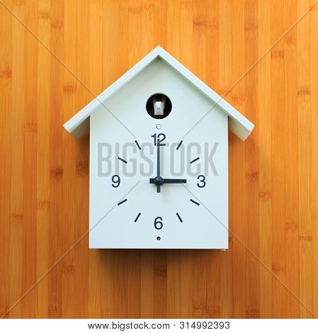 Isolated White Object, Vintage Wall Clock With Birdhouse Style Decorated On Gold Wooden Pattern Wall