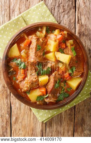 Spezzatino Di Manzo With Potatoes, Carrots And Celery Close-up In A Bowl On The Table. Vertical Top 