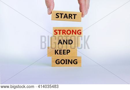 Start Strong And Keep Going Symbol. Concept Words 'start Strong And Keep Going' On Wooden Blocks On 