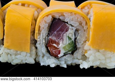 Rolls With Tuna, Chedar Cheese, Rice, Nori, Cream Cheese And Cucumber, Close-up Isolate On Black Bac