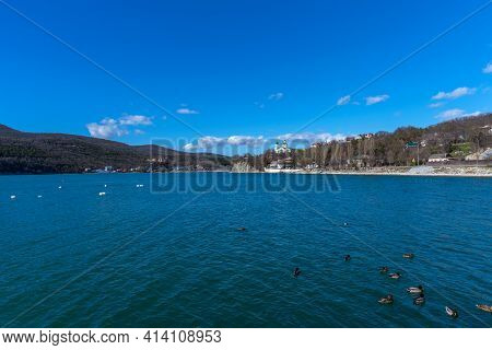 Panoramic View Of Lake Abrau Dyurso In Krasnodar Krai, Russia. Beautiful View Of The Church On The S