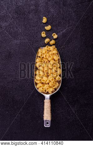 Traditional Dry Pasta On A Black Background. Design Concept. A Copy Of The Space. Selective Focus.