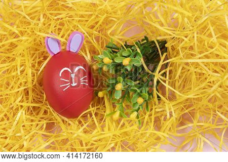 Egg With Easter Rabbit Drawn On Yellow Straw Background