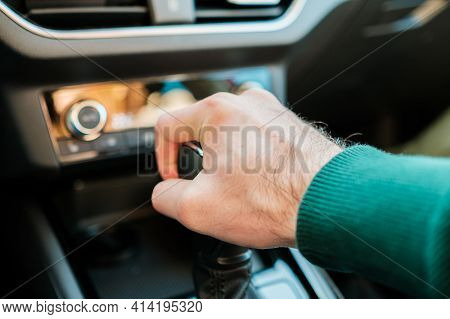 A Mans Hand Shifting Gearbox In The Modern Auto. Man Shifting A Stick Of A Manual Or Automatic Gearb