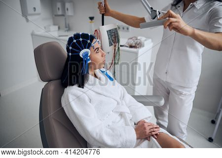 Young Lady Sitting In The Chair During The Eeg Procedure