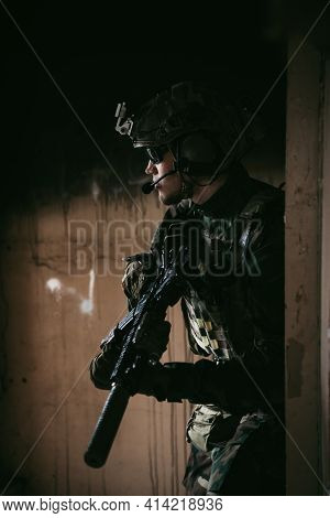 Soldier In Full Us Marsoc Armed With Assault Rifle Run Through The Abandoned Building. Military Clas