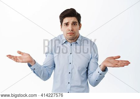 I Dont Know. Clueless Corporate Guy, Office Worker Shrugging Shoulders And Look Confused, Standing P