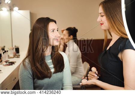Make Up Artist Doing Professional Make Up Of Young Woman. Beauty Shcool.