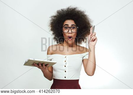 I Have A Great Idea Stusio Portrait Of Excitedd And Smart African Girl In Eyewear Holding A Notebook
