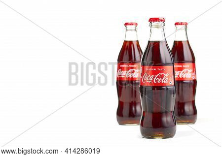 Estonia, Tallinn - 14.02.2021: Coca-cola Classic In A Glass Bottle Isolated On White. Three Bottles 