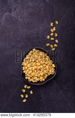 Traditional Dry Pasta On A Black Background. Design Concept. A Copy Of The Space. Selective Focus.