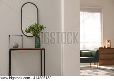 Console Table With Decor And Mirror On Light Wall In Hallway. Interior Design