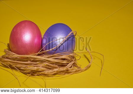Pearl Colored Eggs In The Nest On A Yellow Background. Easter Concept.