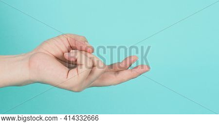 Empty Hand Holding Or Catch Nothing Guesture On Green And Blue Or Mint Background.