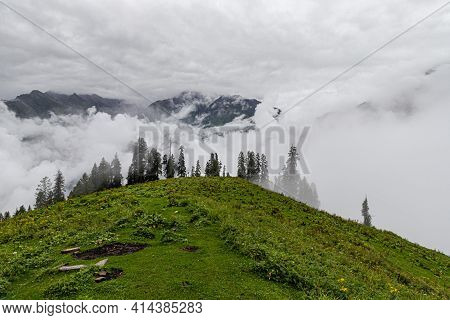 Mesmerizing View Of Clouds In Himachal Pradesh,with Fresh Green Meadows In Bloom.