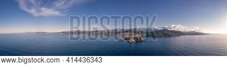 Panoramic Aerial View Of The Red Rock, La Pietra, At Ile Rousse And The Rugged Coastline Of The Bala