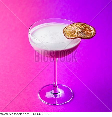 Closeup Glass Of Milk Liquor Based Cocktail On A Purple Background