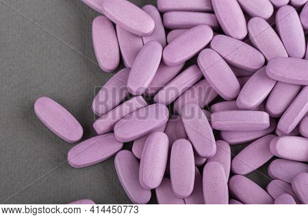 Heap Of Pink Medical Pills On A Gray Background. Health Concept. Top View.