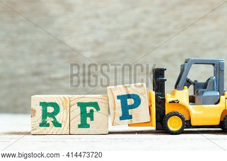 Toy Forklift Hold Letter Block P To Complete Word Rfp (abbreviation Of Request For Proposal) On Wood