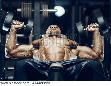 Fit Man Doing Bench Press At Gym.