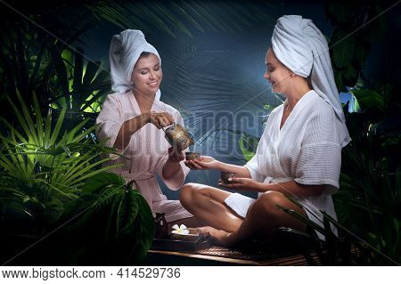 Portrait Of Young Beautiful Women Drinking Tea  In Spa Environment.