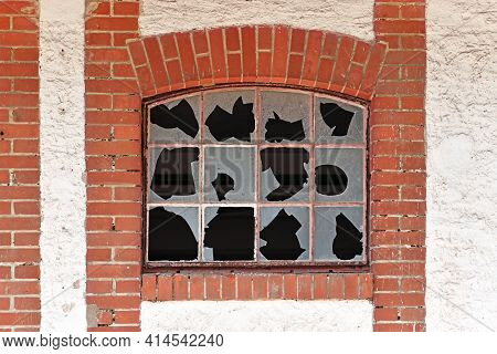 Old Muntin Window With Broken Glass Of Old Abandoned Building With Red Brick Wall Frame